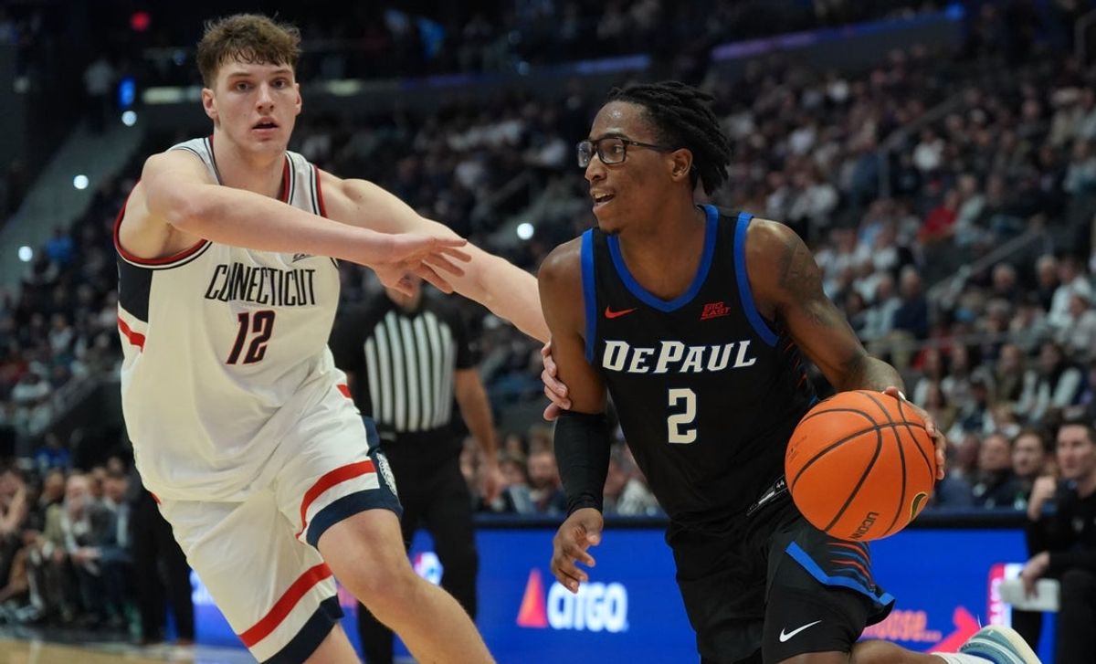 Jan 10, 2026; Hartford, Connecticut, USA; DePaul Blue Demons guard Layden Blocker (2) drives the ball against UConn Huskies center Eric Reibe (12) in the second half at PeoplesBank Arena. Mandatory Credit: David Butler II-Imagn Images