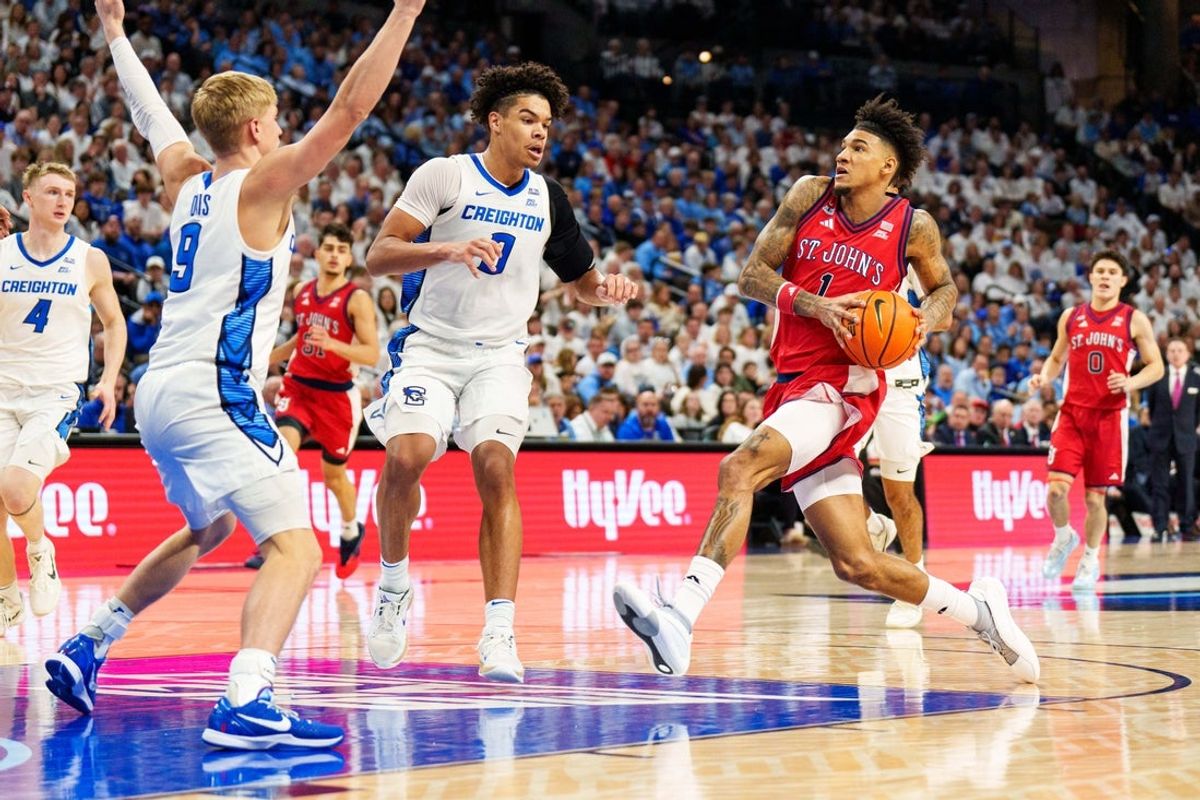 Jan 10, 2026; Omaha, Nebraska, USA; St. John's Red Storm forward Dillon Mitchell (1) drives to the hoop against Creighton Bluejays forward Jasen Green (0) and guard Ty Davis (9) during the first half at CHI Health Center Omaha. Mandatory Credit: Dylan Widger-Imagn Images