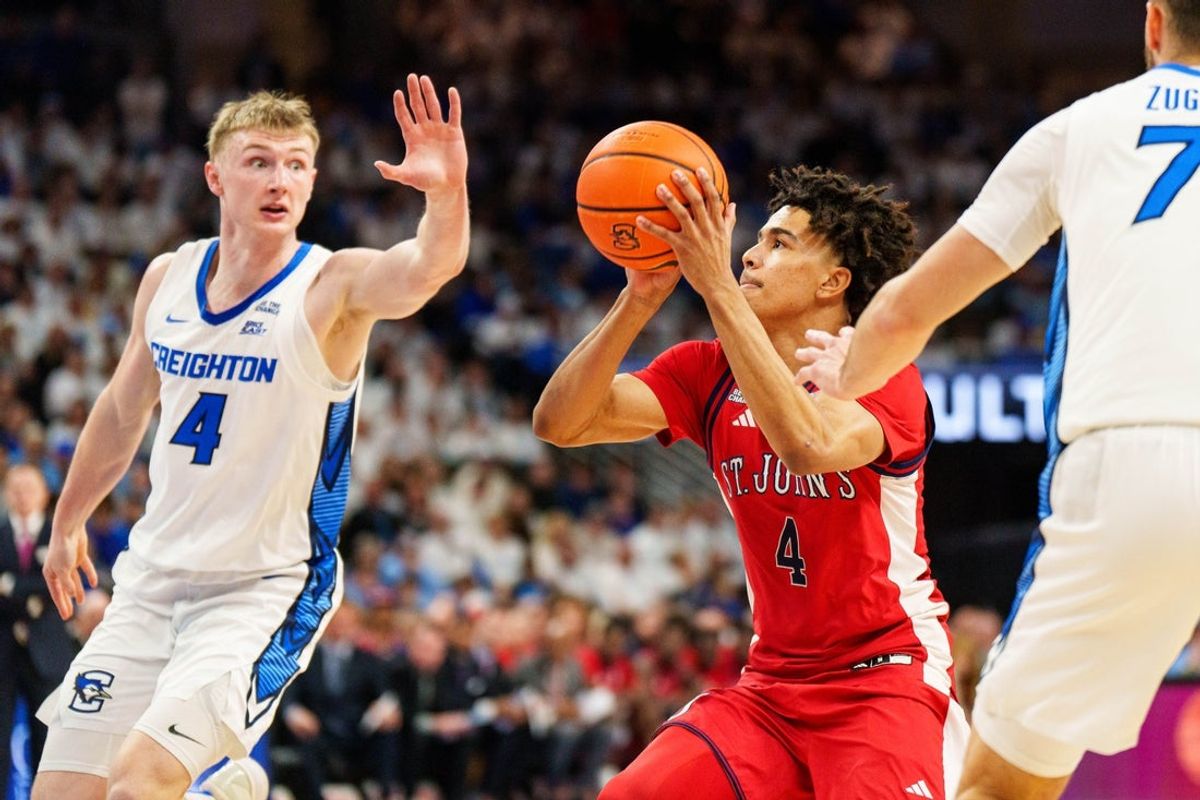 Jan 10, 2026; Omaha, Nebraska, USA; St. John's Red Storm guard Oziyah Sellers (4) shoots the ball against Creighton Bluejays guard Josh Dix (4) and guard Fedor Žugic (7) during the first half at CHI Health Center Omaha. Mandatory Credit: Dylan Widger-Imagn Images