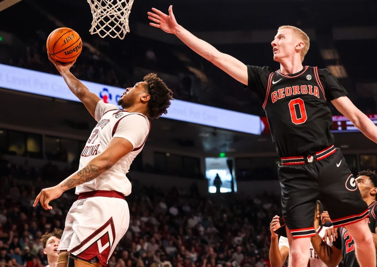 Jan 10, 2026; Columbia, South Carolina, USA; South Carolina Gamecocks forward Elijah Strong (31) drives past Georgia Bulldogs guard Blue Cain (0) in the first half at Colonial Life Arena. Mandatory Credit: Jeff Blake-Imagn Images