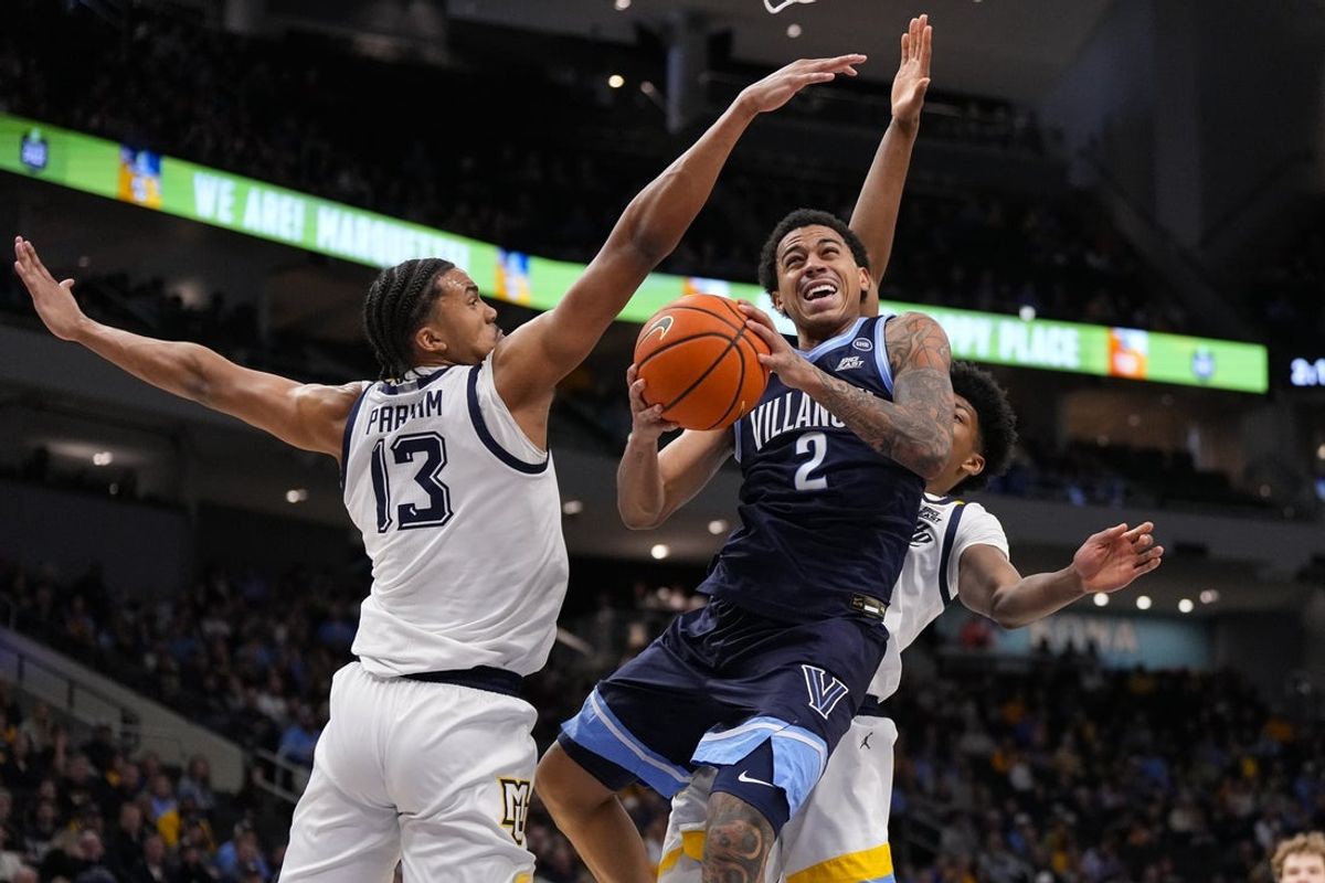 Jan 10, 2026; Milwaukee, Wisconsin, USA;  Villanova Wildcats guard Bryce Lindsay (2) shoots against Marquette Golden Eagles forward Royce Parham (13) during the first half at Fiserv Forum. Mandatory Credit: Jeff Hanisch-Imagn Images