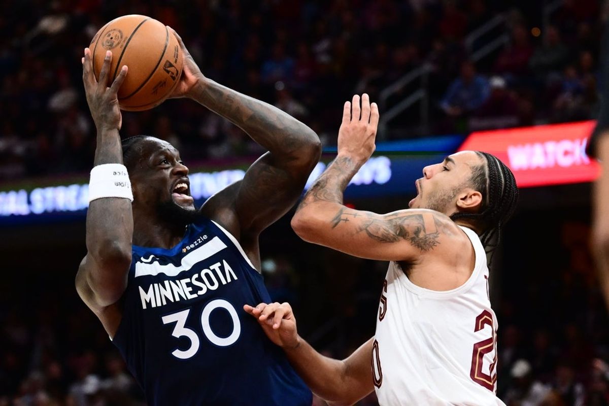 Jan 10, 2026; Cleveland, Ohio, USA; Minnesota Timberwolves forward Julius Randle (30) drives to the basket against Cleveland Cavaliers guard Jaylon Tyson (20) during the second half at Rocket Arena. Mandatory Credit: Ken Blaze-Imagn Images