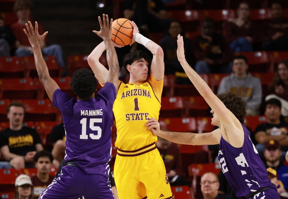 Jan 10, 2026; Tempe, Arizona, USA; Arizona State Sun Devils forward Santiago Trouet (1) looks to pass the ball against Kansas State Wildcats forward Taj Manning (15) in the first half at Desert Financial Arena. Mandatory Credit: Mark J. Rebilas-Imagn Images