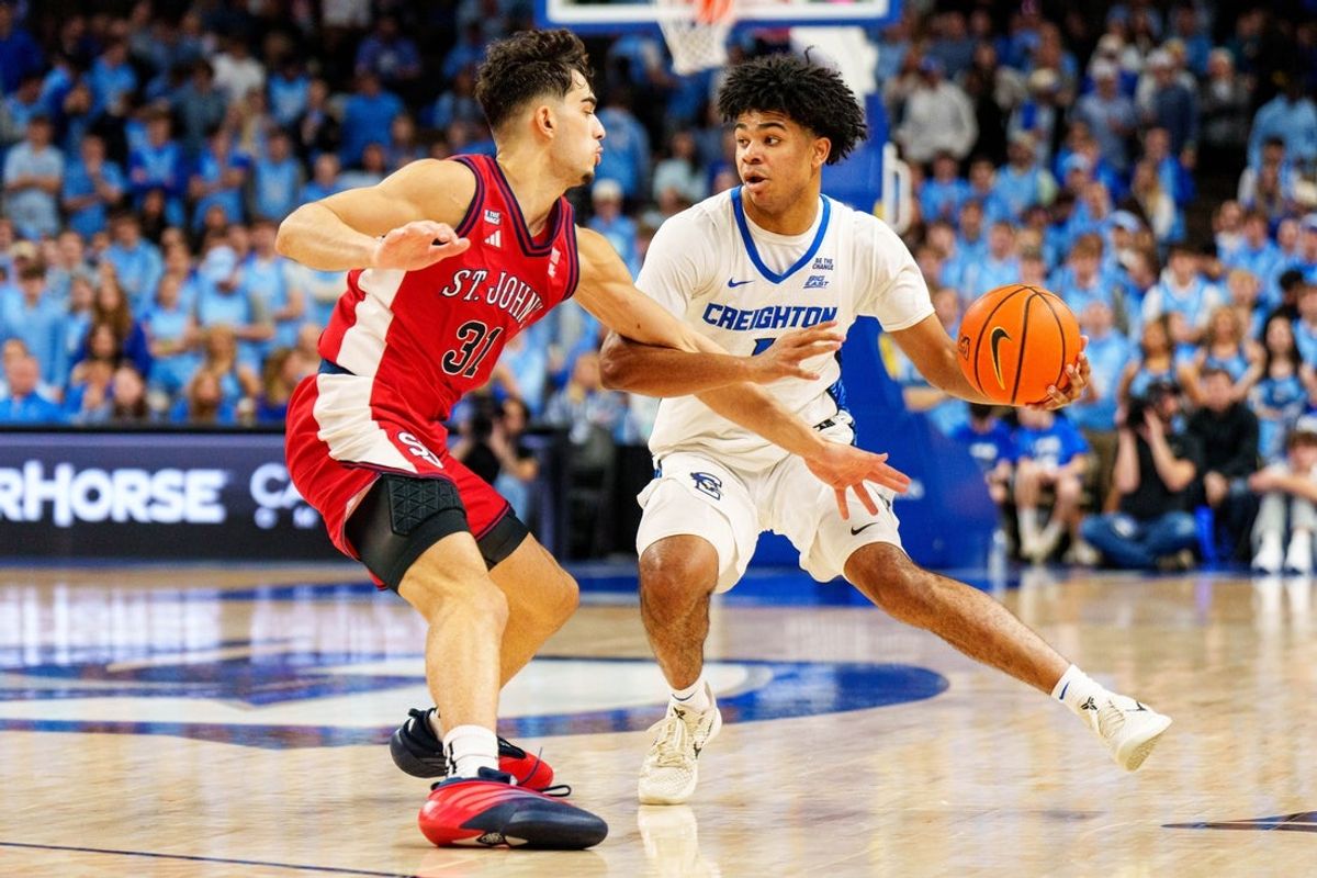 Jan 10, 2026; Omaha, Nebraska, USA; Creighton Bluejays guard Austin Swartz (1) drives against St. John's Red Storm guard Lefteris Liotopoulos (31) during the second half at CHI Health Center Omaha. Mandatory Credit: Dylan Widger-Imagn Images