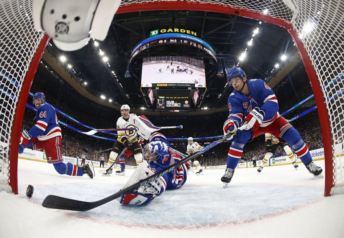 Jan 10, 2026; Boston, Massachusetts, USA; New York Rangers defenseman Braden Schneider (4) (right) reaches for the puck but can’t keep it from crossing the goal line for a score by Boston Bruins center Pavel Zacha (18) during the first period at TD Garden. Mandatory Credit: Winslow Townson-Imagn Images
