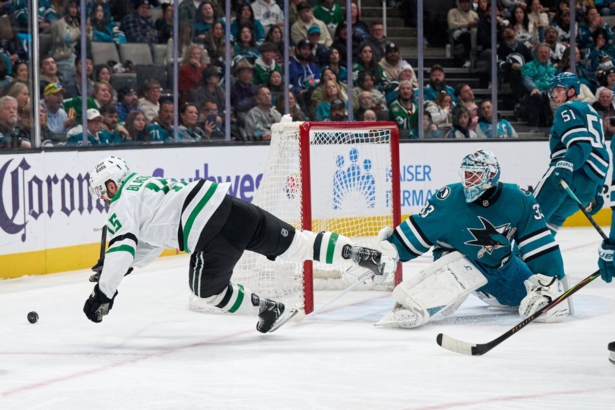 Jan 10, 2026; San Jose, California, USA; Jan 10, 2026; San Jose, California, USA; Dallas Stars center Colin Blackwell (15) is upended after shooting the puck against San Jose Sharks goalkeeper Alex Nedeljkovic (33) during the first period at SAP Center at San Jose. Mandatory Credit: Robert Edwards-Imagn Images