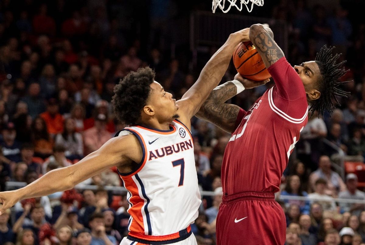 Auburn Tigers forward Keyshawn Hall (7) blocks Arkansas Razorbacks forward Nick Pringle (23) as Auburn Tigers take on Arkansas Razorbacks at Neville Arena in Auburn, Ala. on Saturday, Jan. 10, 2026.