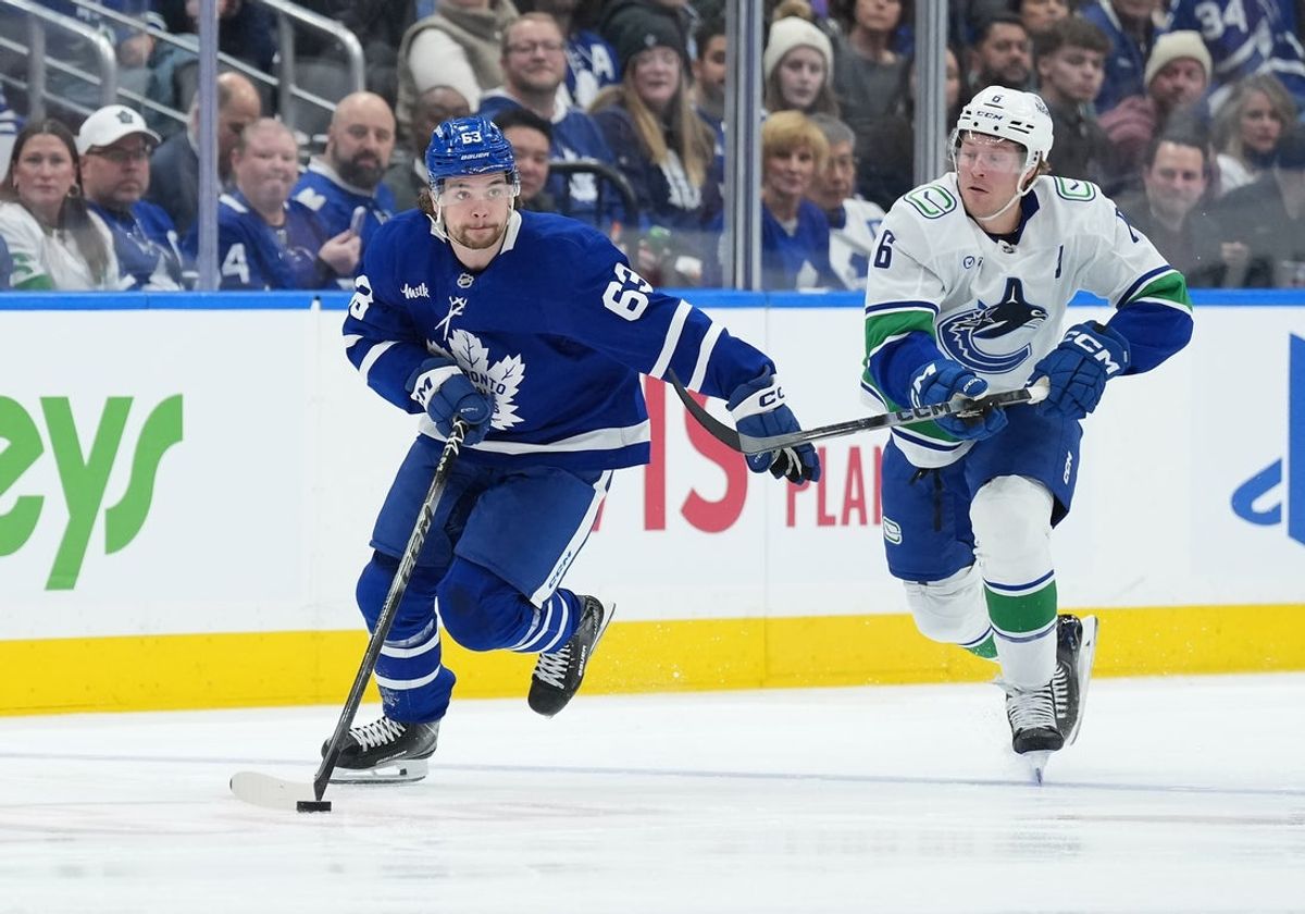 Jan 10, 2026; Toronto, Ontario, CAN; Toronto Maple Leafs left wing Matias Maccelli (63) skates with the puck as Vancouver Canucks right wing Brock Boeser (6) gives chase during the first period at Scotiabank Arena. Mandatory Credit: Nick Turchiaro-Imagn Images