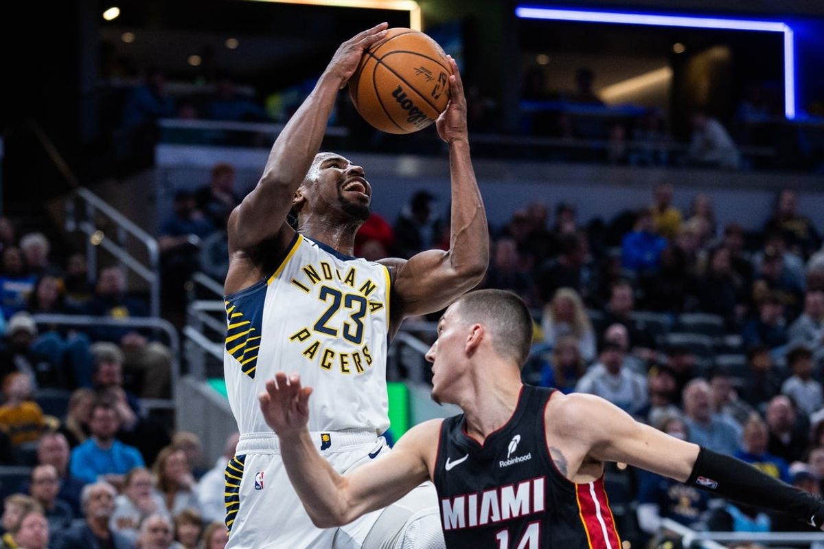 Jan 10, 2026; Indianapolis, Indiana, USA; Indiana Pacers guard/forward Aaron Nesmith (23) shoots the ball while Miami Heat guard Tyler Herro (14) defends in the first half at Gainbridge Fieldhouse. Mandatory Credit: Trevor Ruszkowski-Imagn Images