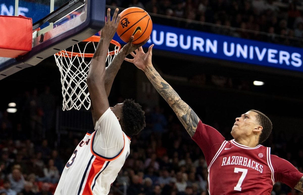 Auburn Tigers forward KeShawn Murphy (3) goes up for a layup on Arkansas Razorbacks forward Trevon Brazile (7) as Auburn Tigers take on Arkansas Razorbacks at Neville Arena in Auburn, Ala. on Saturday, Jan. 10, 2026. Auburn Tigers defeated Arkansas Razorbacks 95-73.