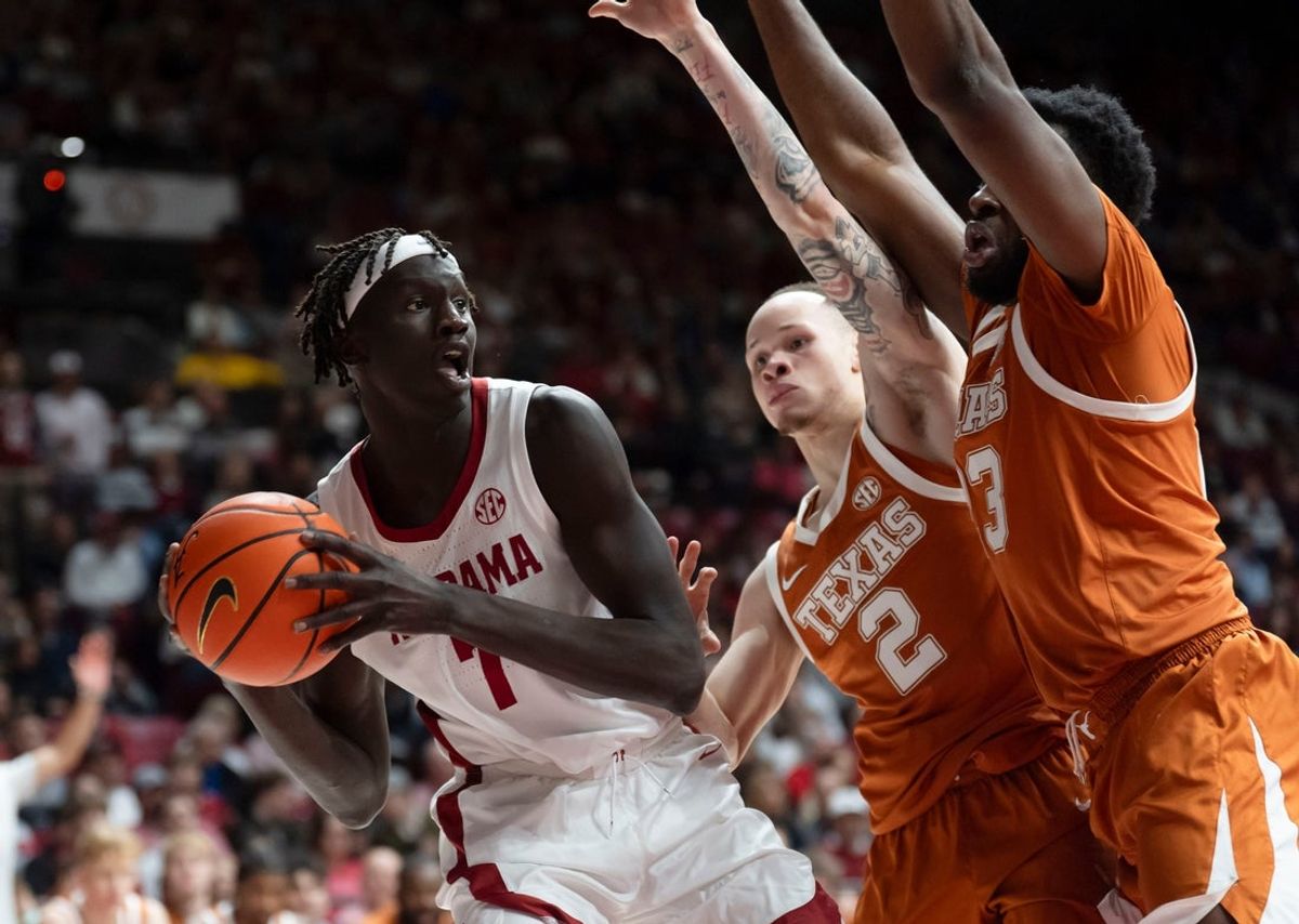 Jan 10, 2026; Tuscaloosa, AL, USA; Alabama forward Taylor Bol Bowen (7) is cut off by Texas guard Chendall Weaver (2) qnd Texas forward Lassina Traore (23) at Coleman Coliseum. Mandatory Credit: Gary Cosby Jr.-Tuscaloosa News