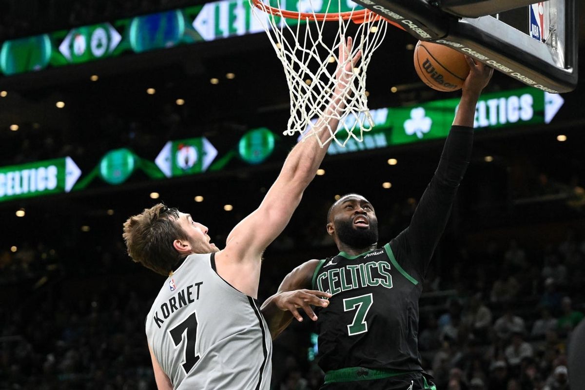 Jan 10, 2026; Boston, Massachusetts, USA; San Antonio Spurs center Luke Kornet (7) defends Boston Celtics guard Jaylen Brown (7) during the second half at the TD Garden. Mandatory Credit: Brian Fluharty-Imagn Images