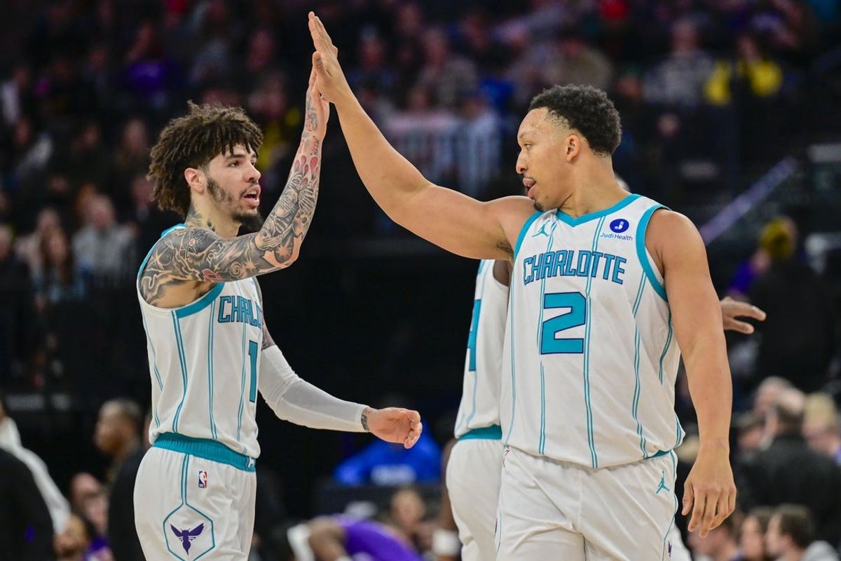 Jan 10, 2026; Salt Lake City, Utah, USA; Charlotte Hornets forward Grant Williams (2) and Charlotte Hornets guard LaMelo Ball (1) celebrate after making shot during the first half at Delta Center. Mandatory Credit: Peter Creveling-Imagn Images