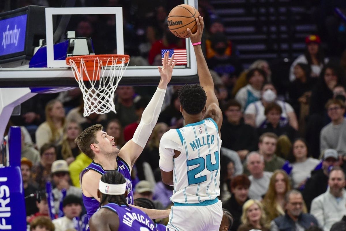 Jan 10, 2026; Salt Lake City, Utah, USA; Utah Jazz center Kyle Filipowski (22) looks to block a shot from Charlotte Hornets forward Brandon Miller (24) during the first half at Delta Center. Mandatory Credit: Peter Creveling-Imagn Images