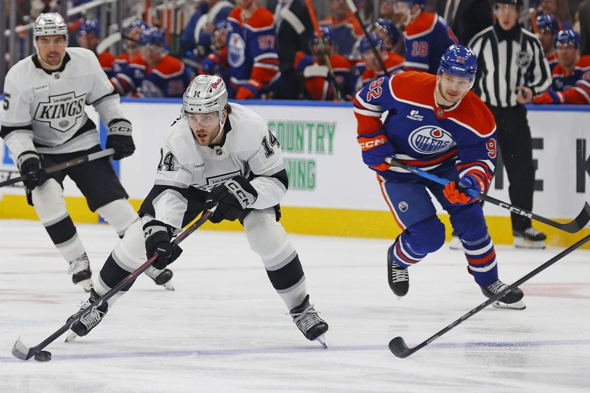 Jan 10, 2026; Edmonton, Alberta, CAN; Los Angeles Kings forward Alex Laferrièrere (14) looks to make a pass in front of Edmonton Oilers forward Vasily Podkolzin (92) during the second period at Rogers Place. Mandatory Credit: Perry Nelson-Imagn Images