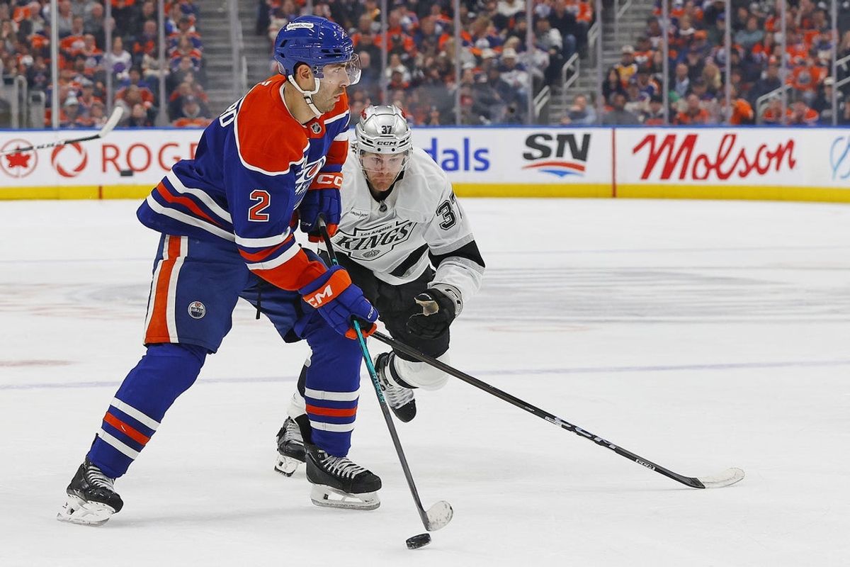Jan 10, 2026; Edmonton, Alberta, CAN; Edmonton Oilers defensemen Evan Bouchard (2) looks to make a pass in front of Los Angeles Kings forward Warren Foegele (37) during the third period at Rogers Place. Mandatory Credit: Perry Nelson-Imagn Images