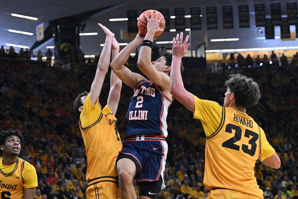 Jan 11, 2026; Iowa City, Iowa, USA; Illinois Fighting Illini guard Andrej Stojakovic (2) shoots the ball as Iowa Hawkeyes guard Isaia Howard (23) and forward Alvaro Folgueiras (7) and guard Isaia Howard (23) defend during the first half at Carver-Hawkeye Arena. Mandatory Credit: Jeffrey Becker-Imagn Images