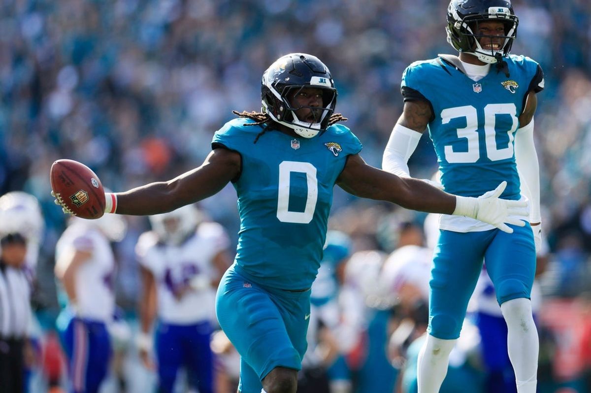 Jacksonville Jaguars linebacker Devin Lloyd (0) celebrates a fumble recovery with cornerback Montaric Brown (30) during the second quarter of an NFL football AFC Wild Card playoff matchup, Sunday, Jan. 11, 2026, in Jacksonville, Fla. [Corey Perrine/Florida Times-Union]