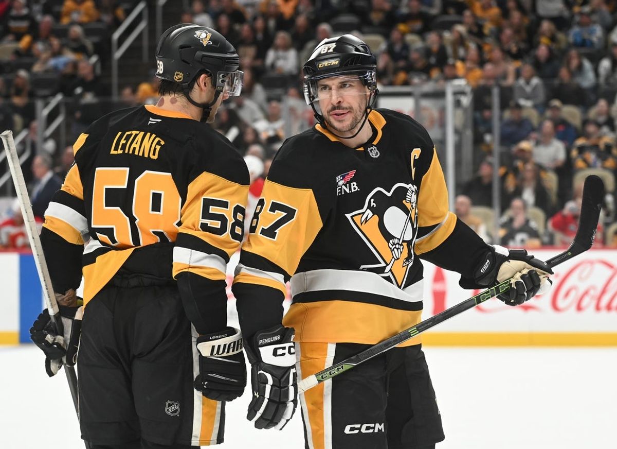 Jan 10, 2026; Pittsburgh, Pennsylvania, USA;  Pittsburgh Penguins center Sidney Crosby (87) and defenseman Kris Letang (58) talk during a break against the Calgary Flames during the third period at PPG Paints Arena. Mandatory Credit: Philip G. Pavely-Imagn Images