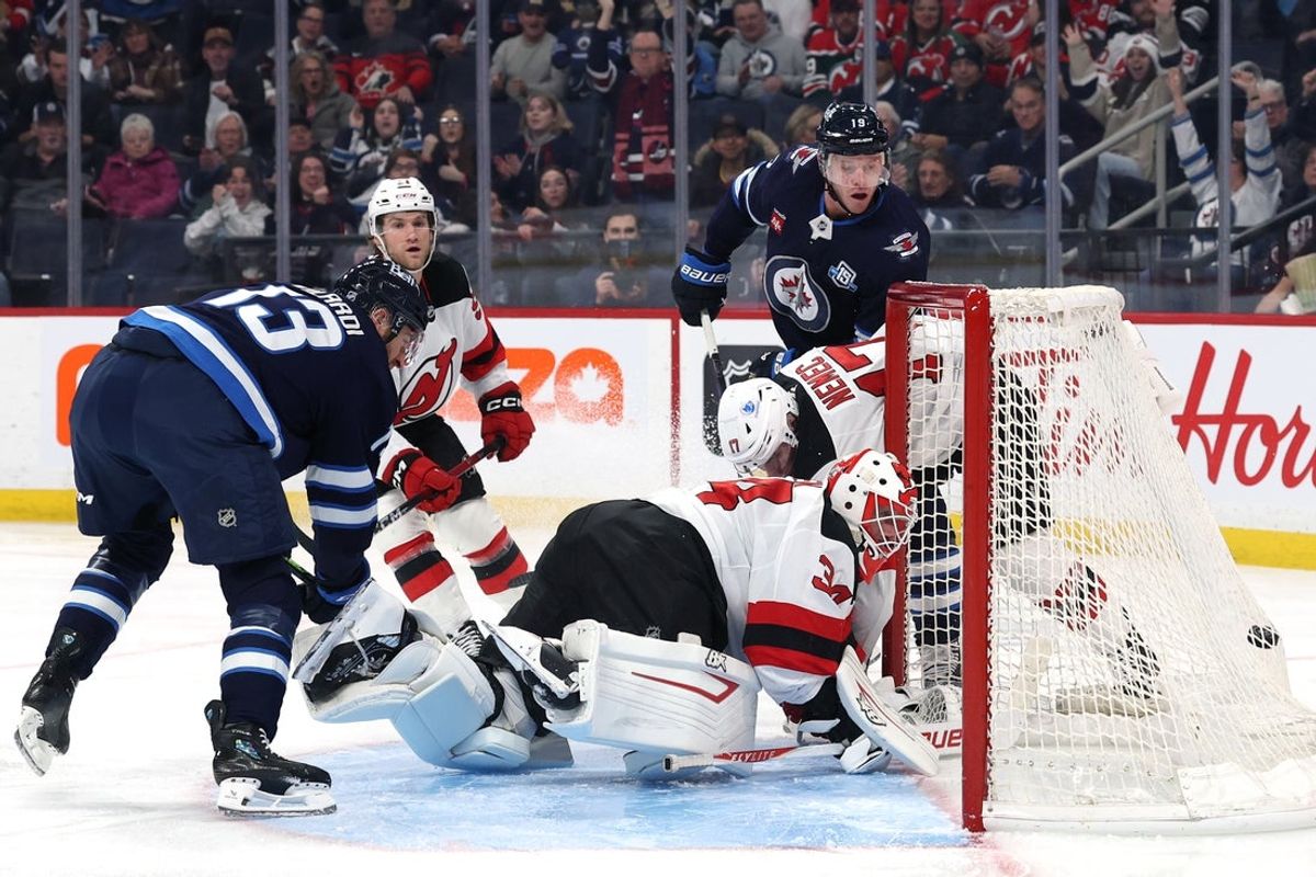 Jan 11, 2026; Winnipeg, Manitoba, CAN; Winnipeg Jets center Jonathan Toews (19) scores on New Jersey Devils goaltender Jake Allen (34) in the second period at Canada Life Centre. Mandatory Credit: James Carey Lauder-Imagn Images
