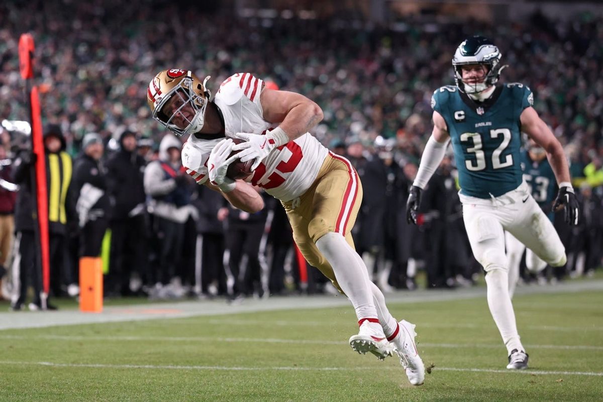 Jan 11, 2026; Philadelphia, PA, USA; San Francisco 49ers running back Christian McCaffrey (23) makes a catch for a touchdown defended by Philadelphia Eagles safety Reed Blankenship (32) during the fourth quarter in an NFC Wild Card Round game at Lincoln Financial Field. Mandatory Credit: Bill Streicher-Imagn Images