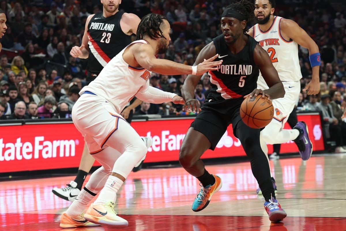 Jan 11, 2026; Portland, Oregon, USA;  Portland Trail Blazers guard Jrue Holiday (5) drives to the basket against New York Knicks guard Jalen Brunson (11) during the first half at Moda Center. Mandatory Credit: Jaime Valdez-Imagn Images