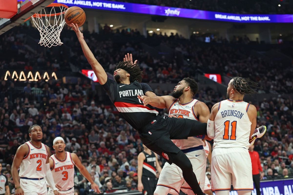 Jan 11, 2026; Portland, Oregon, USA;  Portland Trail Blazers guard Shaedon Sharpe (17)] shoots the ball over New York Knicks center/forward Karl-Anthony Towns (32) during the first half at Moda Center. Mandatory Credit: Jaime Valdez-Imagn Images