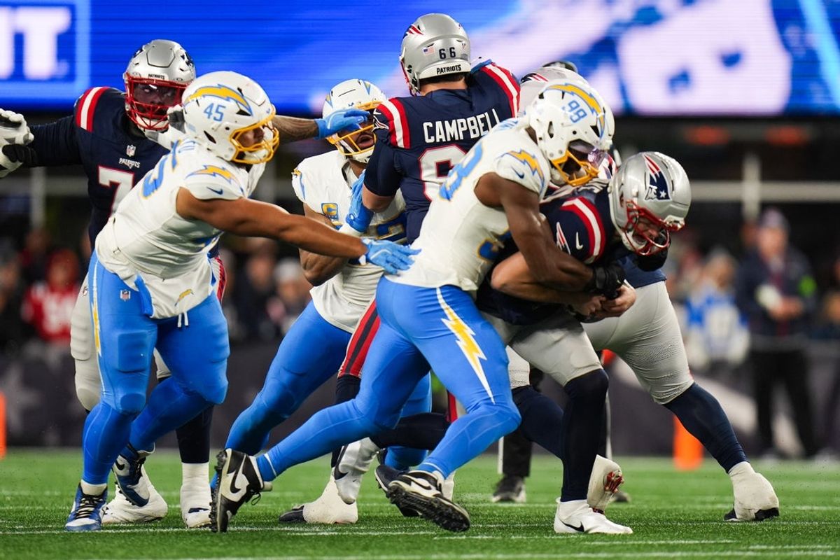 Jan 11, 2026; Foxborough, MA, USA; Los Angeles Chargers linebacker Odafe Oweh (98) and Los Angeles Chargers defensive tackle Justin Eboigbe (92) sack New England Patriots quarterback Drake Maye (10) during the first quarter in an AFC Wild Card Round game at Gillette Stadium. Mandatory Credit: David Butler II-Imagn Images