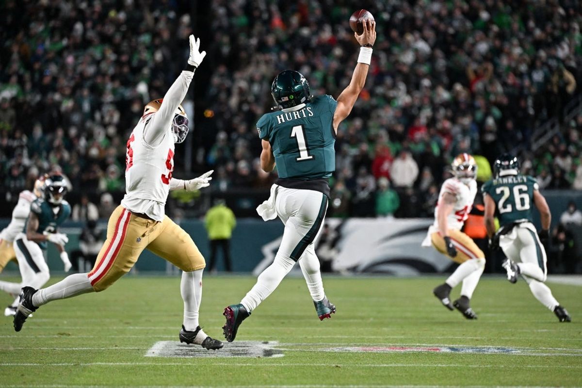 Jan 11, 2026; Philadelphia, PA, USA; Philadelphia Eagles quarterback Jalen Hurts (1) passes the ball under pressure from San Francisco 49ers defensive tackle Sebastian Valdez (55) during the fourth quarter in an NFC Wild Card Round game at Lincoln Financial Field. Mandatory Credit: Eric Hartline-Imagn Images