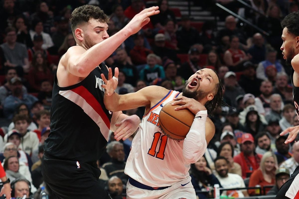Jan 11, 2026; Portland, Oregon, USA;  New York Knicks guard Jalen Brunson (11) drives to the basket past Portland Trail Blazers center Donovan Clingan (23) and forward Toumani Camara (33) during the second half at Moda Center. Mandatory Credit: Jaime Valdez-Imagn Images