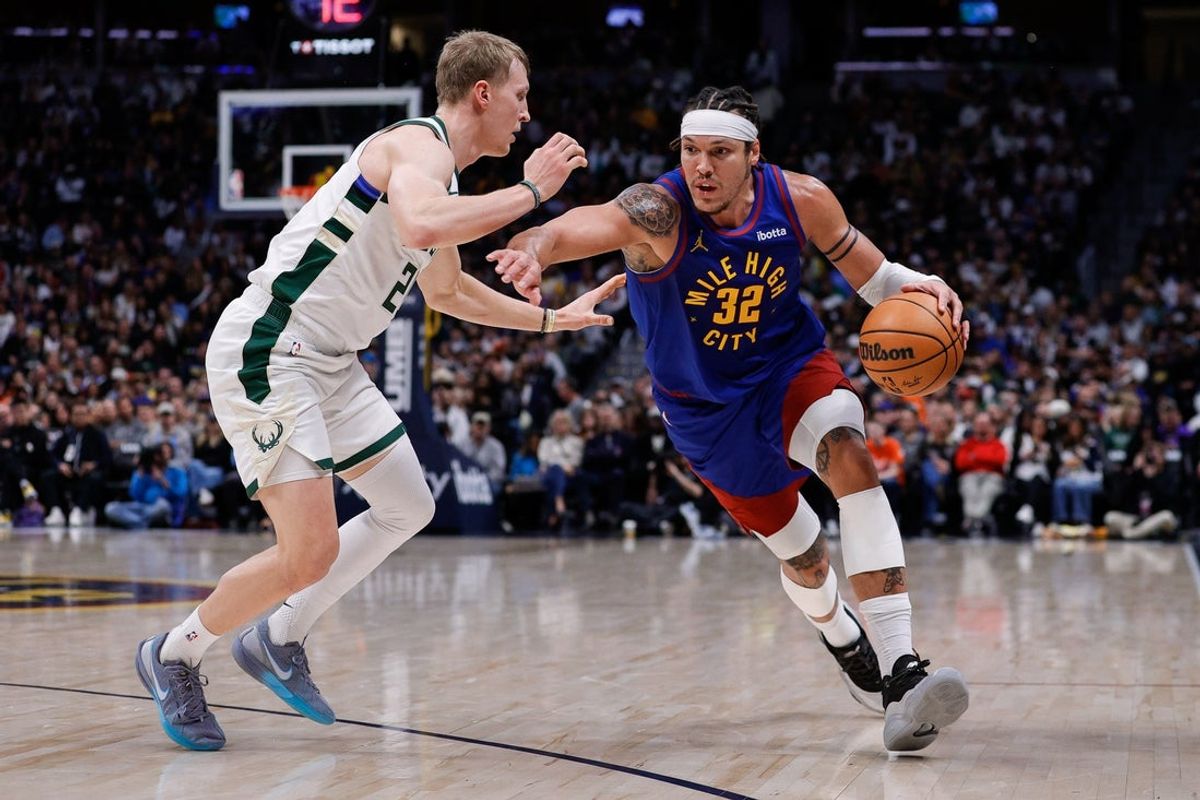 Jan 11, 2026; Denver, Colorado, USA; Denver Nuggets forward Aaron Gordon (32) controls the ball as Milwaukee Bucks guard AJ Green (20) guards in the second quarter at Ball Arena. Mandatory Credit: Isaiah J. Downing-Imagn Images