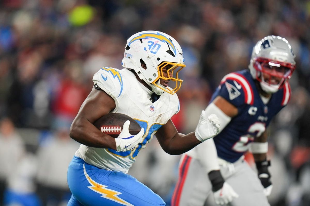 Jan 11, 2026; Foxborough, MA, USA; Los Angeles Chargers running back Kimani Vidal (30) rushes during the third quarter against the New England Patriots in an AFC Wild Card Round game at Gillette Stadium. Mandatory Credit: David Butler II-Imagn Images
