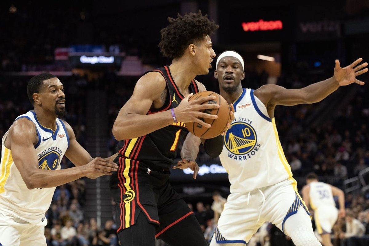 Jan 11, 2026; San Francisco, California, USA; Atlanta Hawks forward Jalen Johnson (1) looks for an open teammate as he is double-teamed by Golden State Warriors guard De'Anthony Melton (8) and forward Jimmy Butler III (10) during the fourth quarter at Chase Center. Mandatory Credit: D. Ross Cameron-Imagn Images