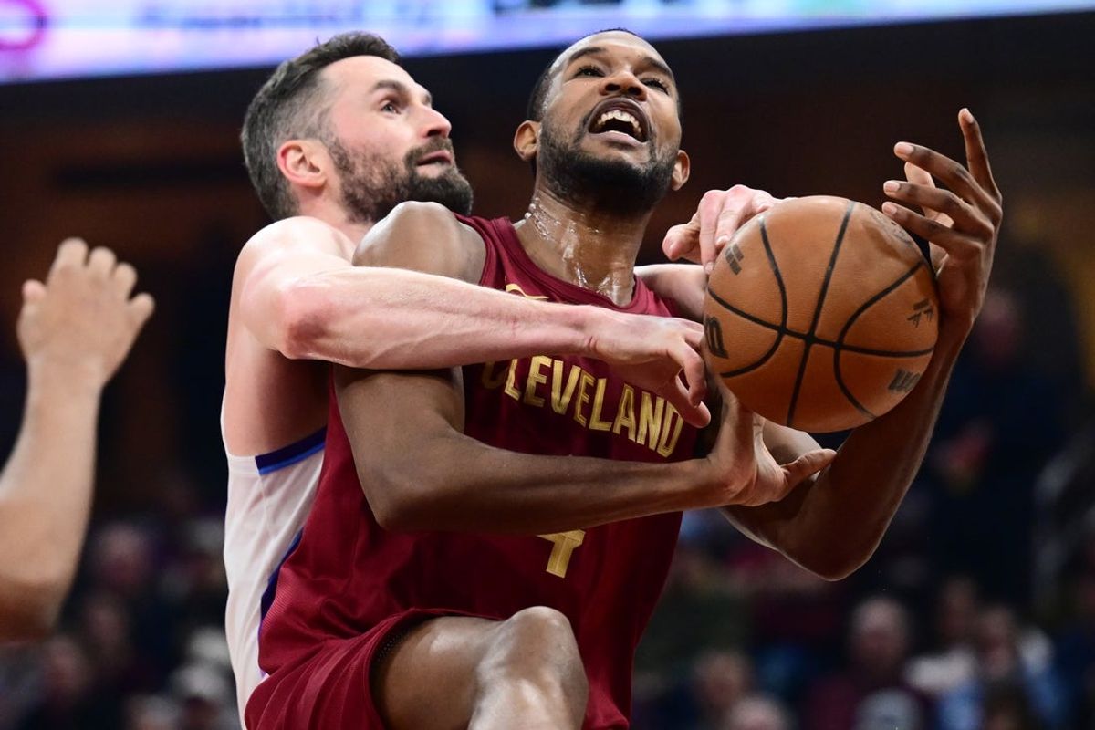 Jan 12, 2026; Cleveland, Ohio, USA; Utah Jazz forward Kevin Love (42) fouls Cleveland Cavaliers center Evan Mobley (4) during the first half at Rocket Arena. Mandatory Credit: Ken Blaze-Imagn Images