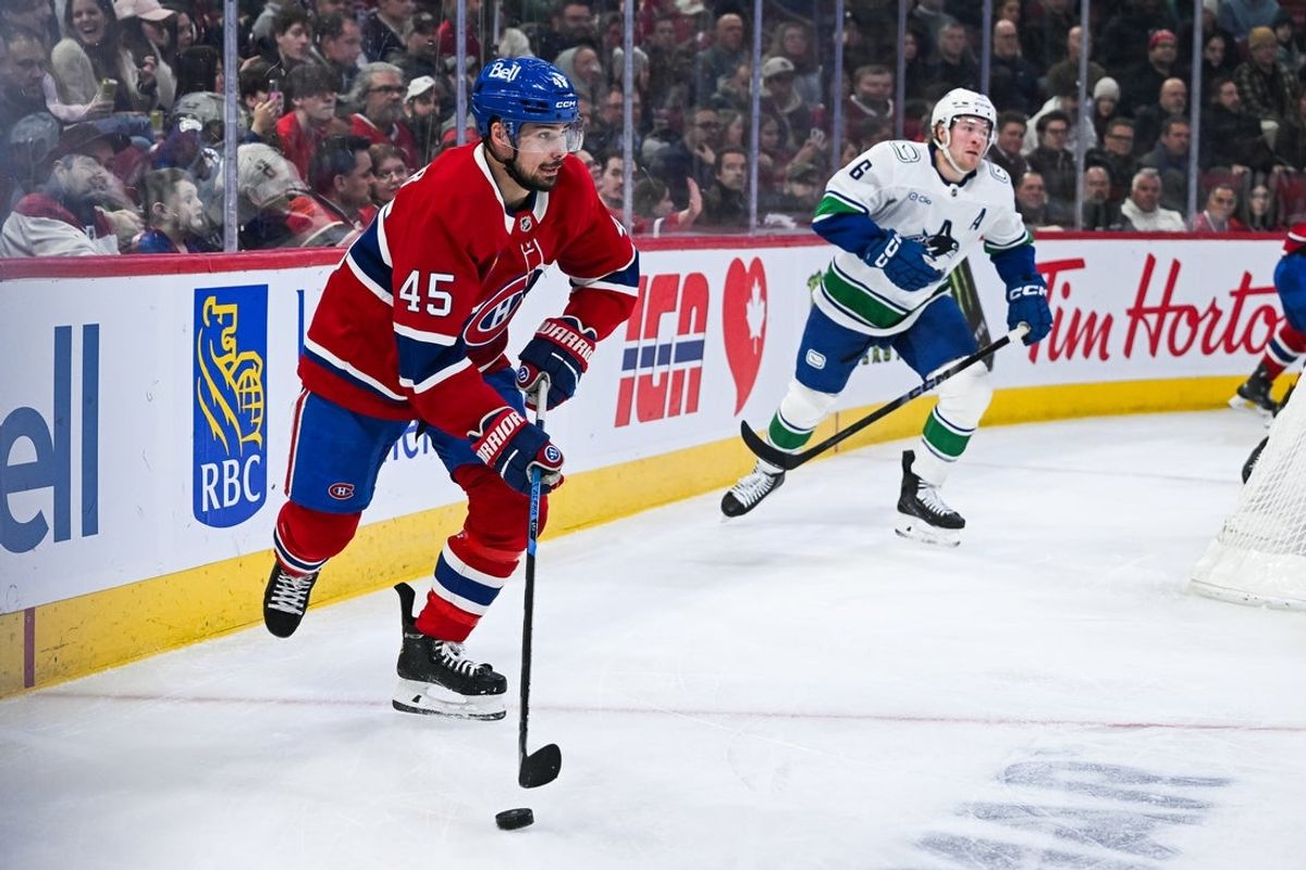 Jan 12, 2026; Montreal, Quebec, CAN; Montreal Canadiens defenseman Alexandre Carrier (45) plays the puck against the Vancouver Canucks during the first period at Bell Centre. Mandatory Credit: David Kirouac-Imagn Images