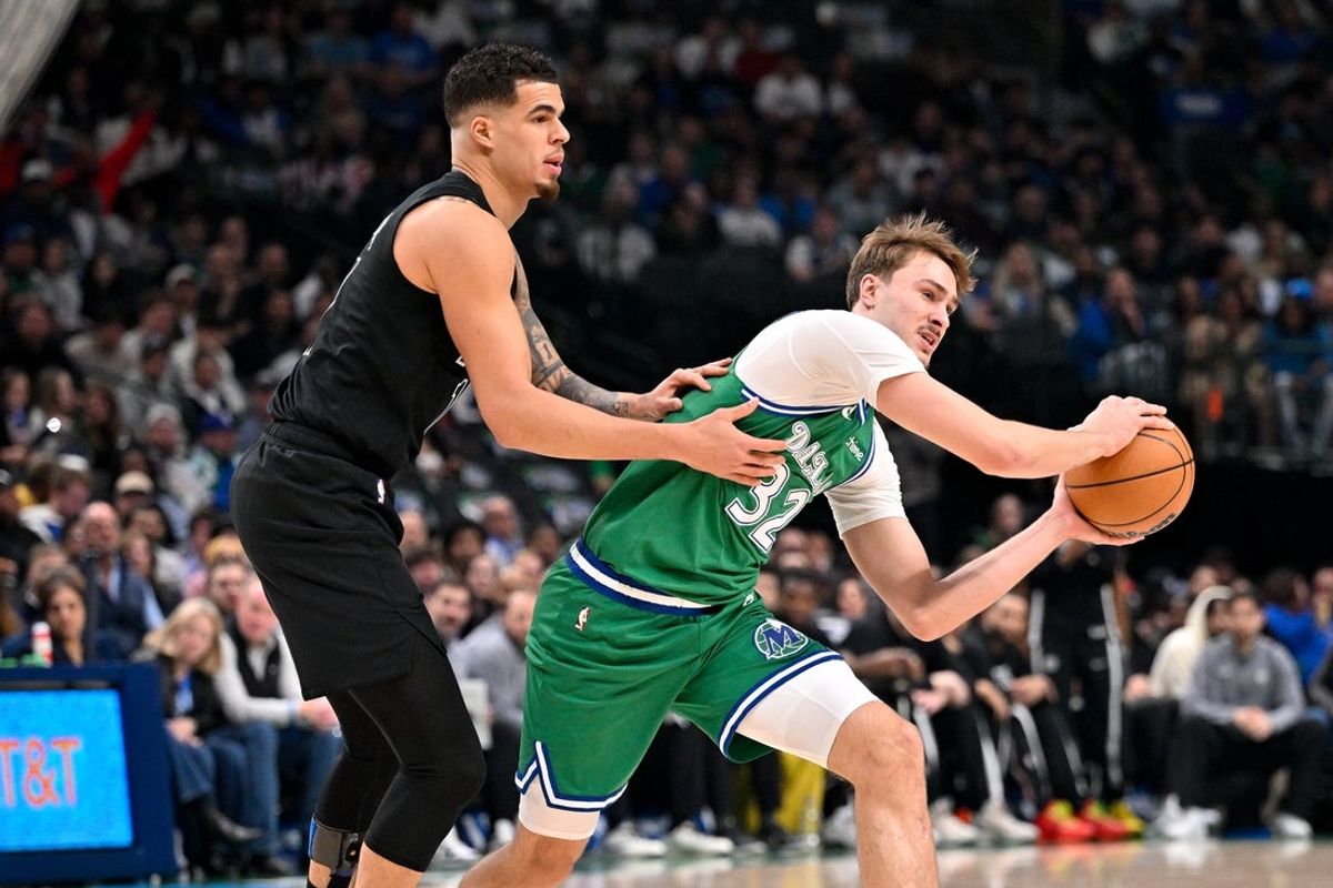 Jan 12, 2026; Dallas, Texas, USA; Dallas Mavericks forward Cooper Flagg (32) looks to move the ball past Brooklyn Nets forward Michael Porter Jr. (17) during the first quarter at the American Airlines Center. Mandatory Credit: Jerome Miron-Imagn Images