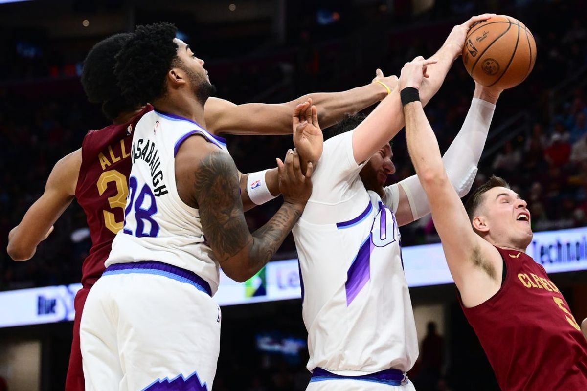 Jan 12, 2026; Cleveland, Ohio, USA; Cleveland Cavaliers guard Sam Merrill (5) goes for a rebound against Utah Jazz forward Brice Sensabaugh (28) and center Jusuf Nurkic (30) during the second half at Rocket Arena. Mandatory Credit: Ken Blaze-Imagn Images