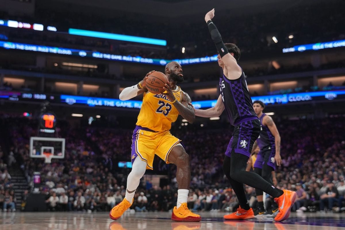 Jan 12, 2026; Sacramento, California, USA; Los Angeles Lakers forward LeBron James (23) drives to the hoop next to Sacramento Kings center Maxime Raynaud (42) in the second quarter at the Golden 1 Center. Mandatory Credit: Cary Edmondson-Imagn Images