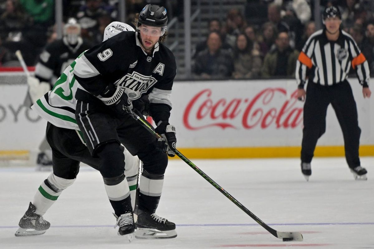 Jan 12, 2026; Los Angeles, California, USA;  Los Angeles Kings right wing Adrian Kempe (9) skates the puck in front of Dallas Stars center Wyatt Johnston (53) in the second period at Crypto.com Arena. Mandatory Credit: Jayne Kamin-Oncea-Imagn Images