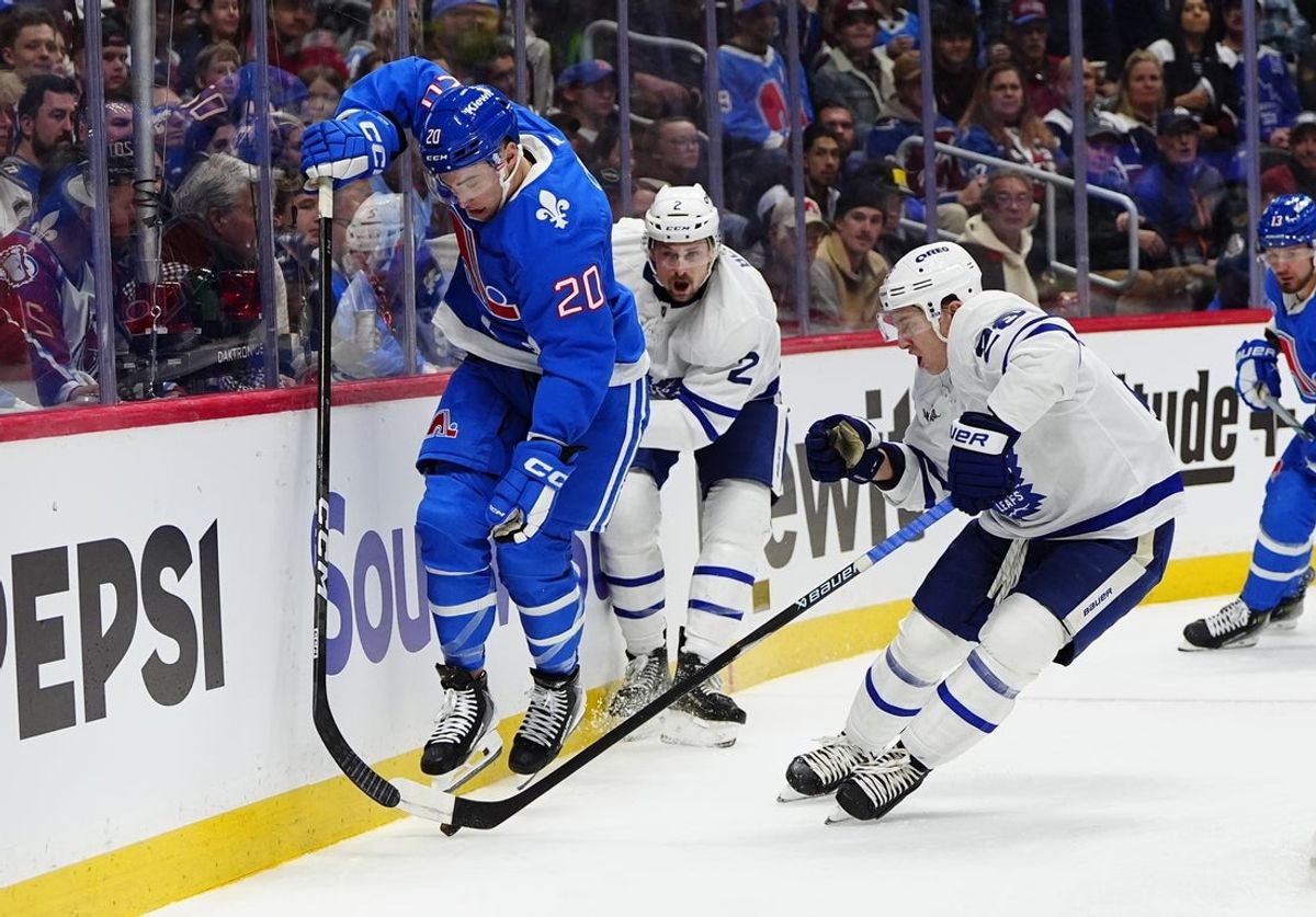 Jan 12, 2026; Denver, Colorado, USA; Toronto Maple Leafs defenseman Troy Stecher (28) and Colorado Avalanche center Ross Colton (20) battle for the puck in the second period at Ball Arena. Mandatory Credit: Ron Chenoy-Imagn Images