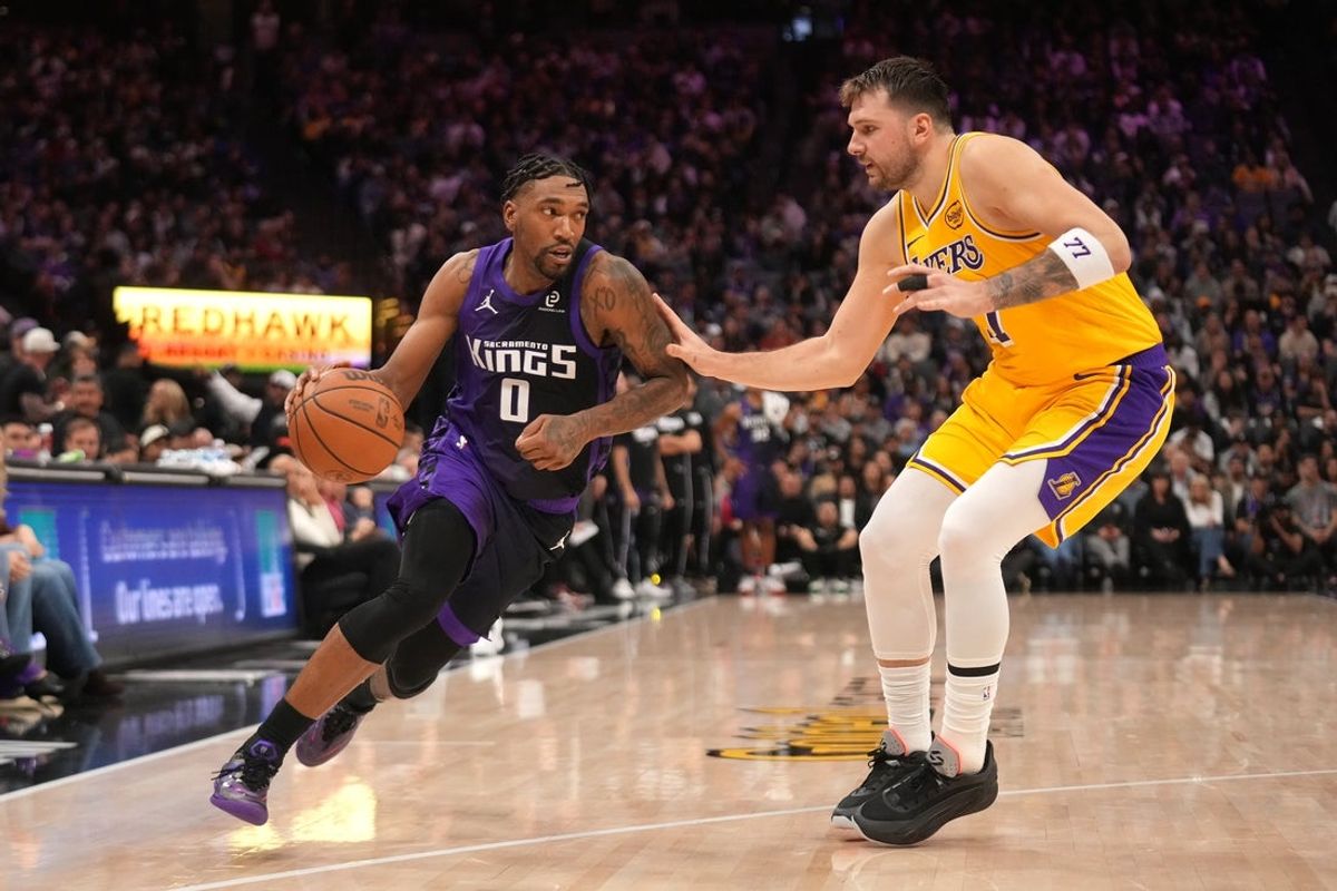 Jan 12, 2026; Sacramento, California, USA; Sacramento Kings guard Malik Monk (0) dribbles the ball next to Los Angeles Lakers guard Luka Doncic (77) in the fourth quarter at the Golden 1 Center. Mandatory Credit: Cary Edmondson-Imagn Images