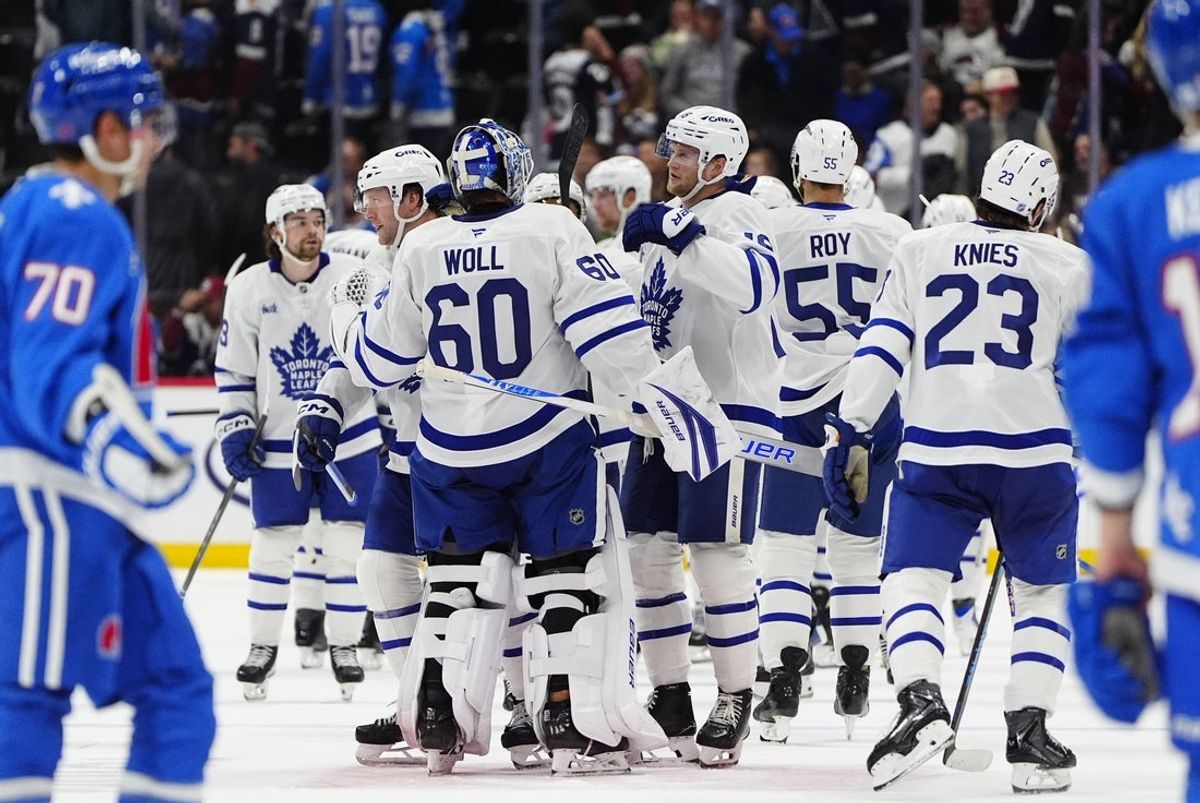 Jan 12, 2026; Denver, Colorado, USA; Members of the Toronto Maple Leafs celebrate defeating the Colorado Avalanche in overtime at Ball Arena. Mandatory Credit: Ron Chenoy-Imagn Images