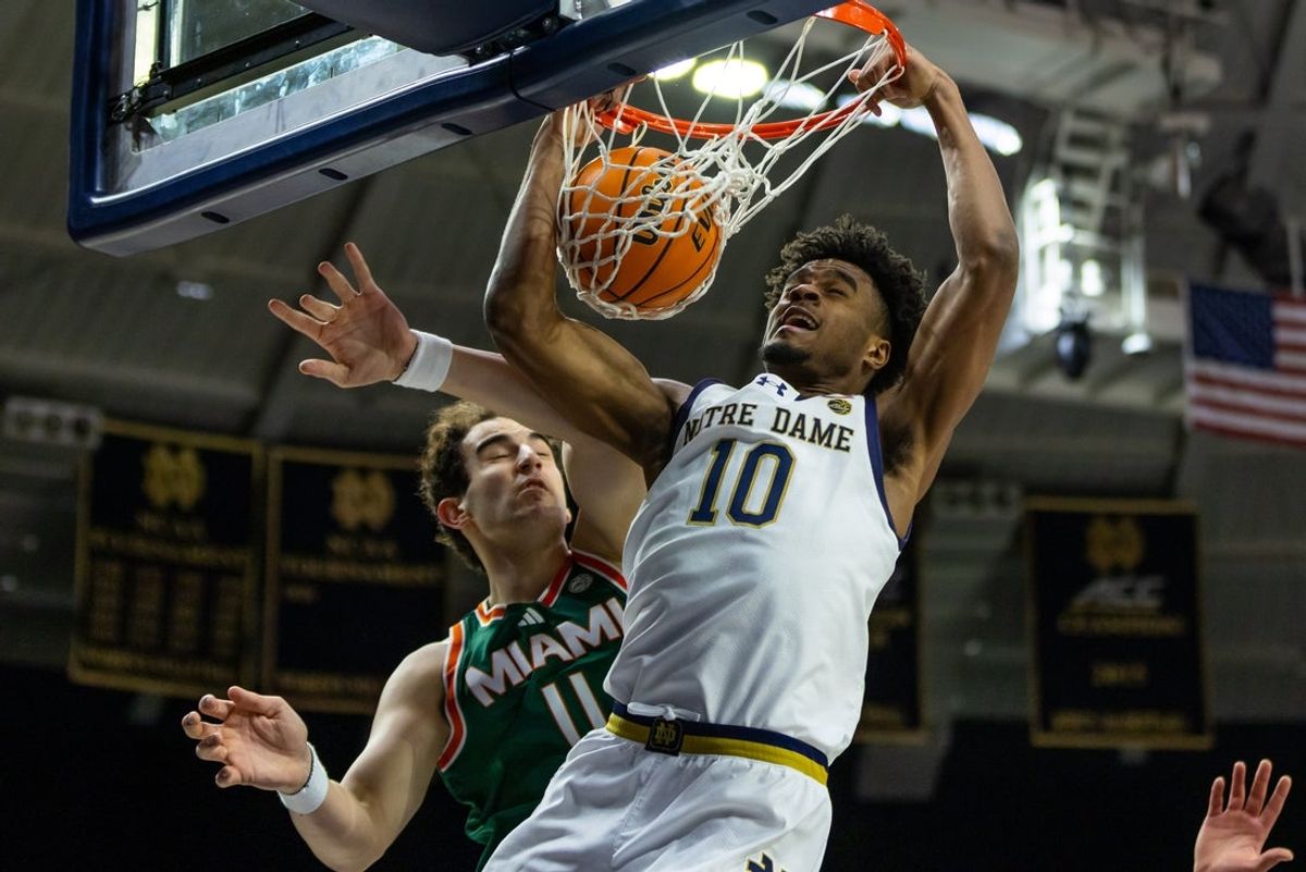 Jan 13, 2026; South Bend, Indiana, USA; Notre Dame Fighting Irish forward Jalen Haralson (10) dunks as Miami (FL) Hurricanes center Salih Altuntas (11) defends during the first half at Purcell Pavilion at the Joyce Center. Mandatory Credit: Michael Caterina-Imagn Images