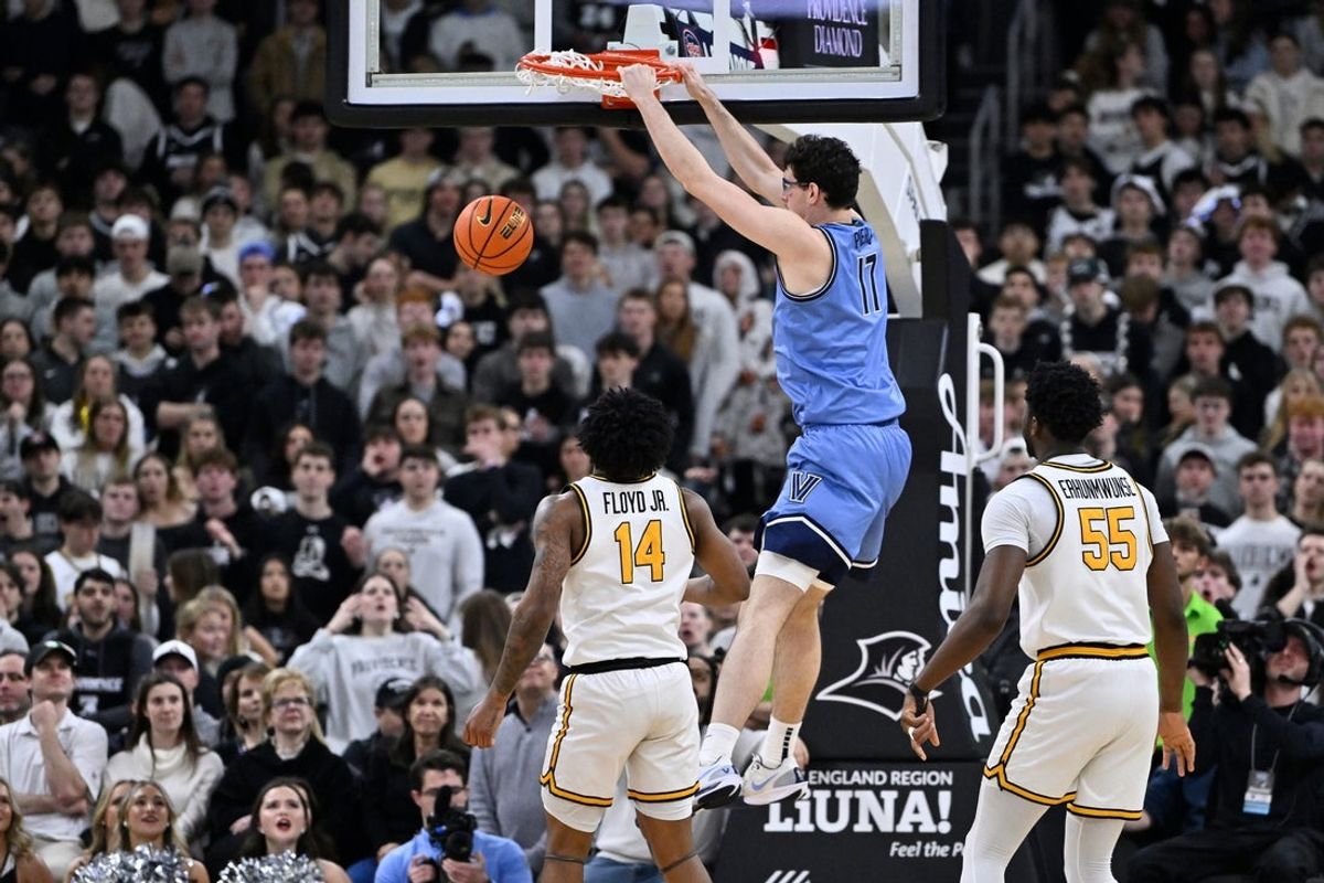 Jan 13, 2026; Providence, Rhode Island, USA; Villanova Wildcats center Braden Pierce (17) hangs from the rim after dunking the ball against the Providence Friars during the first half at Amica Mutual Pavilion. Mandatory Credit: Eric Canha-Imagn Images