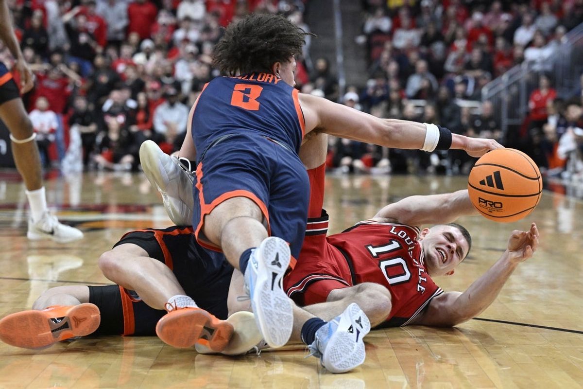 Jan 13, 2026; Louisville, Kentucky, USA;  Louisville Cardinals guard Isaac McKneely (10) and Virginia Cavaliers guard Chance Mallory (2) scramble for a loose ball during the first half at KFC Yum! Center. Mandatory Credit: Jamie Rhodes-Imagn Images