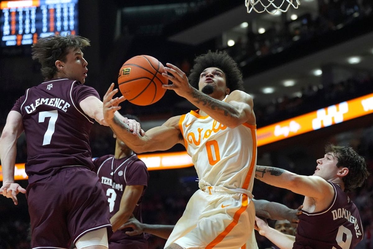 Texas A&M forward Zach Clemence (7) commits a foul on Tennessee guard Ja'Kobi Gillespie (0) as Gillespie shoots the ball during a NCAA basketball game between Tennessee and Texas A&M at Thompson-Boling Arena at Food City Center in Knoxville, Tenn., on Jan. 13, 2026.