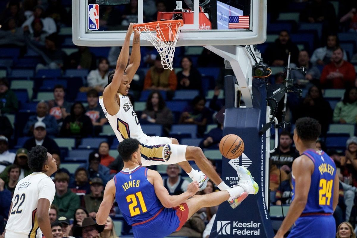 Jan 13, 2026; New Orleans, Louisiana, USA; New Orleans Pelicans forward Trey Murphy III (25) dunks the ball on Denver Nuggets forward Spencer Jones (21) during the first quarter at Smoothie King Center. Mandatory Credit: Matthew Hinton-Imagn Images