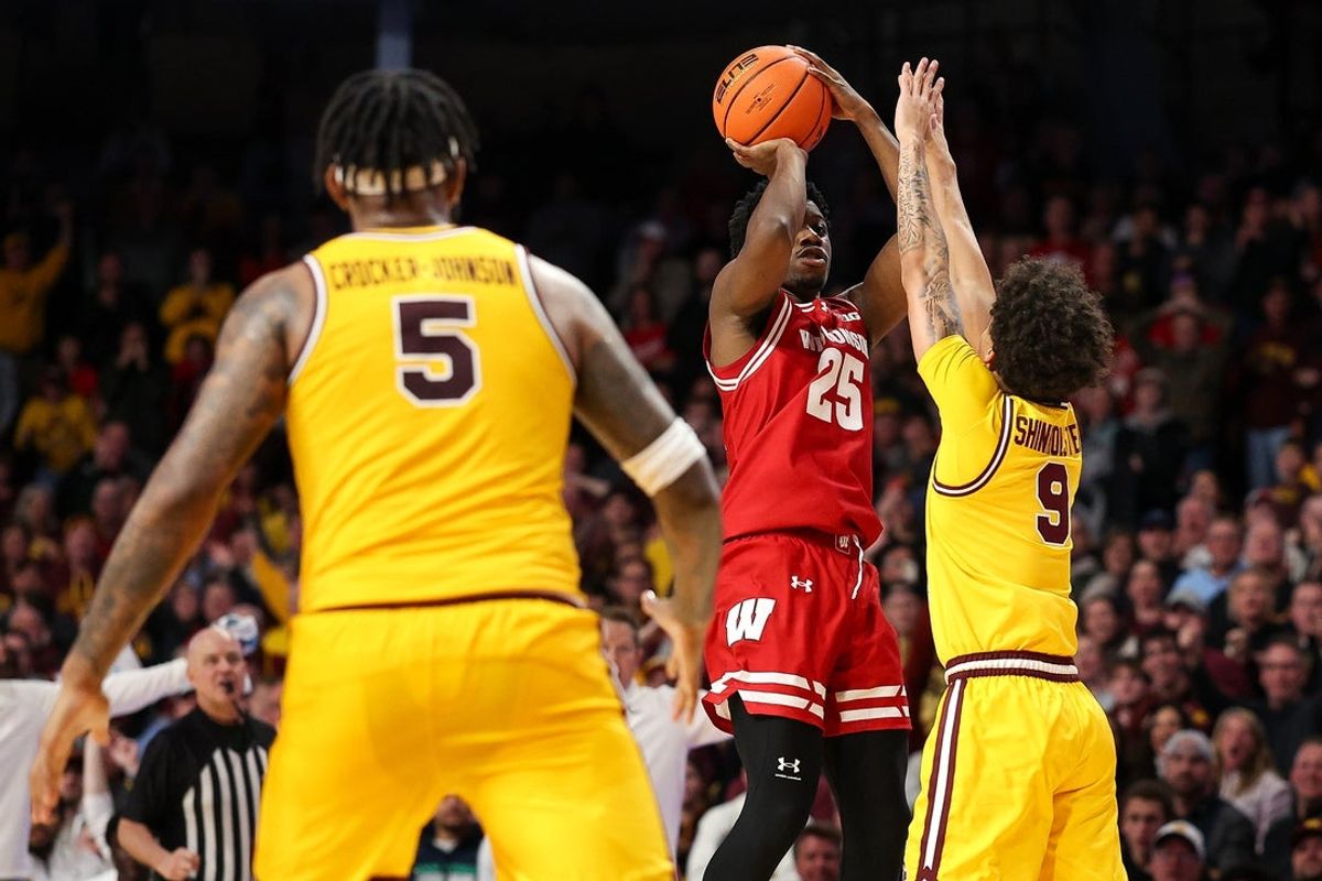 Jan 13, 2026; Minneapolis, Minnesota, USA; Wisconsin Badgers guard John Blackwell (25) shoots the game winning shot as Minnesota Golden Gophers guard Kai Shinholster (9) defends during the second half at Williams Arena. Mandatory Credit: Matt Krohn-Imagn Images