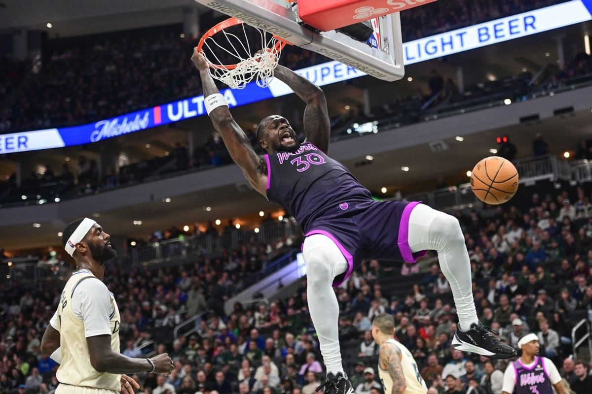 Jan 13, 2026; Milwaukee, Wisconsin, USA; Minnesota Timberwolves forward Julius Randle (30) dunks a basket against Milwaukee Bucks forward Bobby Portis (9) in the second quarter at Fiserv Forum. Mandatory Credit: Benny Sieu-Imagn Images