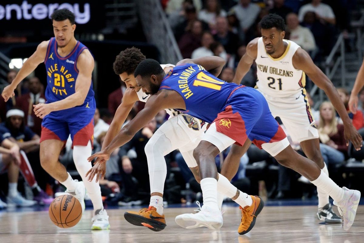 Jan 13, 2026; New Orleans, Louisiana, USA; Denver Nuggets guard Tim Hardaway Jr. (10) and New Orleans Pelicans guard Jordan Poole (3) battle for a loose ball during the first half at Smoothie King Center. Mandatory Credit: Matthew Hinton-Imagn Images